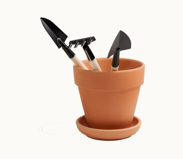 Clay Pot With Wooden Rake and Shovel
